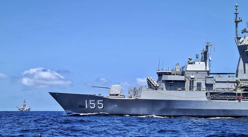 HMAS Ballarat patrols past a large offshore gas platform off the north-west coast of Western Australia. Photo by Able Seaman Connor Webber.