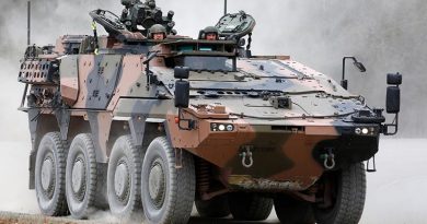 Chief of Army Lieutenant General Rick Burr (left) is taken for a drive in an 8x8 Boxer as soldiers from 2nd/14th Light Horse Regiment undertake familiarisation training on the vehicle at the Greenbank Training Area, Queensland. Photo by Corporal Colin Dadd.