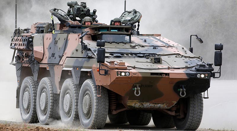 Chief of Army Lieutenant General Rick Burr (left) is taken for a drive in an 8x8 Boxer as soldiers from 2nd/14th Light Horse Regiment undertake familiarisation training on the vehicle at the Greenbank Training Area, Queensland. Photo by Corporal Colin Dadd.