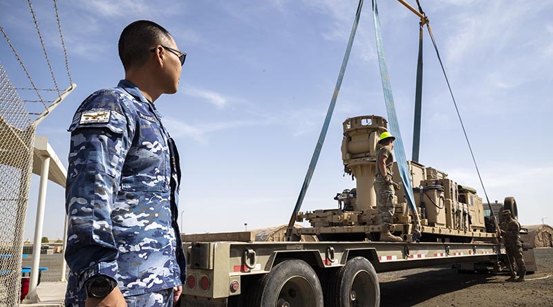 Detachment Commander Squadron Leader Kevin Lee oversees the removal of communications equipment at Camp McNamara in the Middle East before the Aussie base is handed back to the US Air Force. Photo by Corporal Tristan Kennedy.