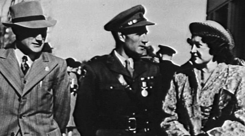 Captain Bede Tongs (centre) with his wife and his brother Reginald after being presented his Military Medal by the Governor-General in Canberra, July 1947. Australian War Memorial photo 134820.