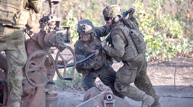 Gunner Thalia Tabuai (right) of 8th/12th Regiment, Royal Australian Artillery, and US Marine Corps Corporal Kevin Dominic Matias ram a high-explosive projectile into the breach of an M777A2 Howitzer. Photo by Corporal Rodrigo Villablanca.