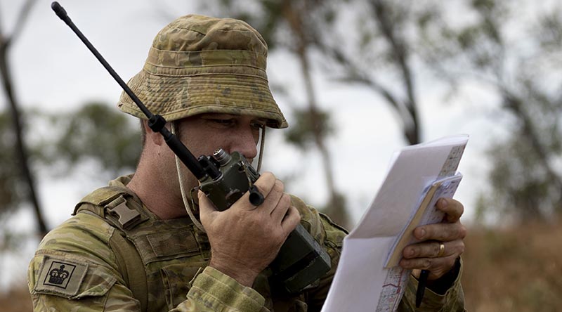 Australian Army Warrant Officer Class Two Matthew Hazelton, from the 4th Regiment, Royal Australian Artillery, communicates with a Royal Australian Air Force, F/A-18F Super Hornet pilot during Exercise Nigrum Pugio at Townsville Field Training Area on 14 October 2020. Photo by Captain Lily Charles.