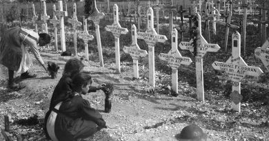 French children tend the graves of Australians killed in battle on the Western Front. AWM E05925