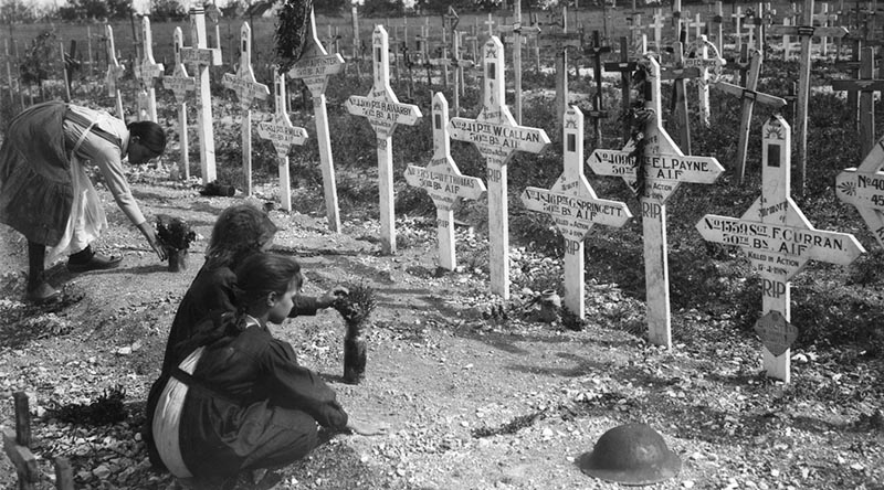 French children tend the graves of Australians killed in battle on the Western Front. AWM E05925