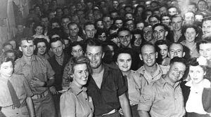 Members of HQ 7 Division and 7 Div Provost, packed in for a dance with members of the Australian Army Medical Women's Service, the Women's Land Army and civilians at the Koala Club on 15 November 1944. Photo from Australian War Memorial (083186).