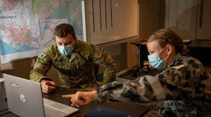 Lieutenant Jeremy Rooke, left, and Lieutenant Tracey Magyar analyse data during Operation COVID-19 Assist in Victoria. Photo by Corporal Daniel Strutt.