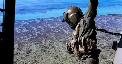 Petty Officer Rhys Withers in an MRH-90 helicopter looks over Elizabeth Reef during an unexploded ordnance clearance mission. Photo by Sergeant Jake Sims.