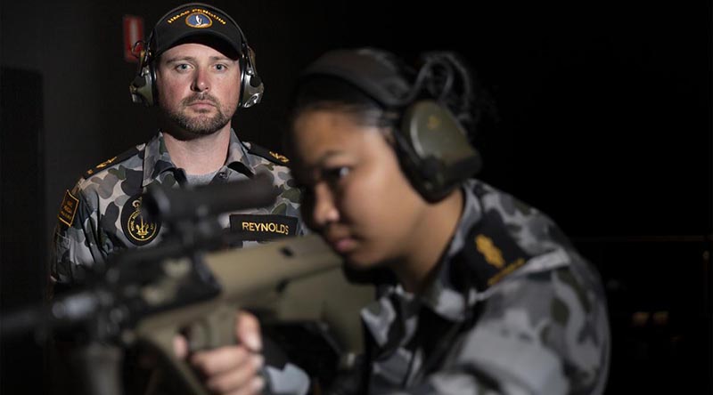 Leading Seaman Bradley Reynolds supervises Able Seaman Armilyn Pontanes during a live-fire serial at the new Weapons Training Simulation System at HMAS Penguin. Photo by Leading Seaman Nadav Harel.