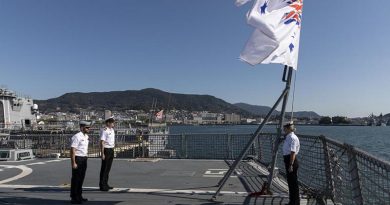 Members of HMAS Arunta's ship's company stand at attention during a Remembrance Day ceremony while alongside Sasebo Naval Base, Japan. Photo by Leading Seaman Jarrod Mulvihill.