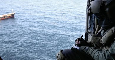 Leading Seaman Aircrewman Brad Firkin collects information on a vessel of interest from HMAS Arunta's MH-60R Seahawk helicopter during Operation Argos. Photo by Leading Seaman Jarrod Mulvihill.