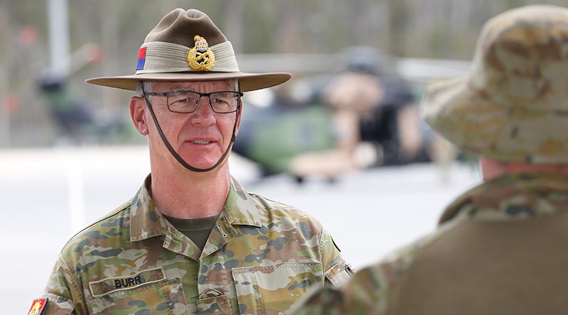 Chief of Army Lieutenant General Rick Burr talks to a soldier at Greenbank Training Area, Queensland. Photo by Corporal Colin Dadd.