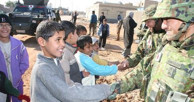 Iraqi children shake hands with JGSDF soldiers during a reconstruction operation. Photo by Rikujojieitai Boueisho, via WikiCommons.