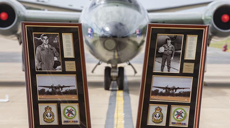 Framed commemorations of Flying Officer Michael Herbert and Pilot Officer Robert Carver positioned in front of a Canberra bomber during a 50th anniversary commemorative service at RAAF Base Williamtown. Photo by Corporal Brett Sherriff.