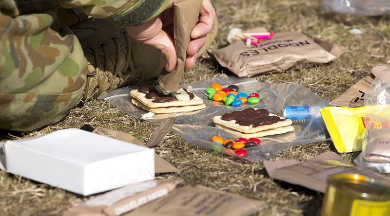 An Australian Army staff cadet from Royal Military College, Duntroon, combines ingredients during a lecture on ration packs at the Majura training area. Photo by Sergeant Bill Solomou.