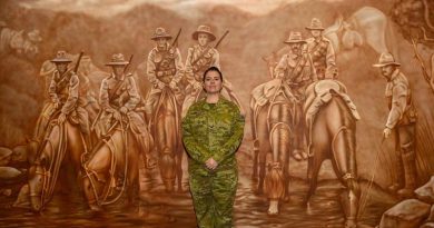 Lance Corporal Jessica Haines-Hann in front of the mural she painted at the Gallipoli Barracks Sergeants' Mess.