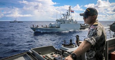 Lieutenant Bradley Chivers of HMAS Wollongong keeps watch during a coordinated maritime patrol in waters between Australia and Indonesia with KRI Pandrong and KRI Lemadang. Photographer unknown.