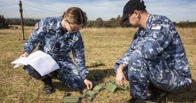 Leading Aircraftwoman Kate Kershaw and Leading Aircraftman Jordan Hopkins erect an aerial for the UXO TrackS system trial. Photo by Sergeant Shane Gidall.