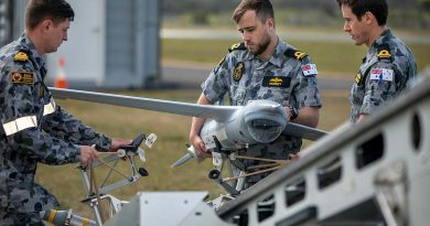 Members of the first Remote Pilot Warfare Officer course load a ScanEagle unmanned aircraft to the launcher before a flight at Jervis Bay Airfield. Photo by Chief Petty Officer Cameron Martin.