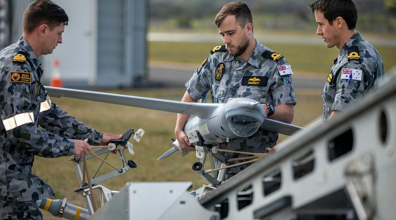Members of the first Remote Pilot Warfare Officer course load a ScanEagle unmanned aircraft to the launcher before a flight at Jervis Bay Airfield. Photo by Chief Petty Officer Cameron Martin.