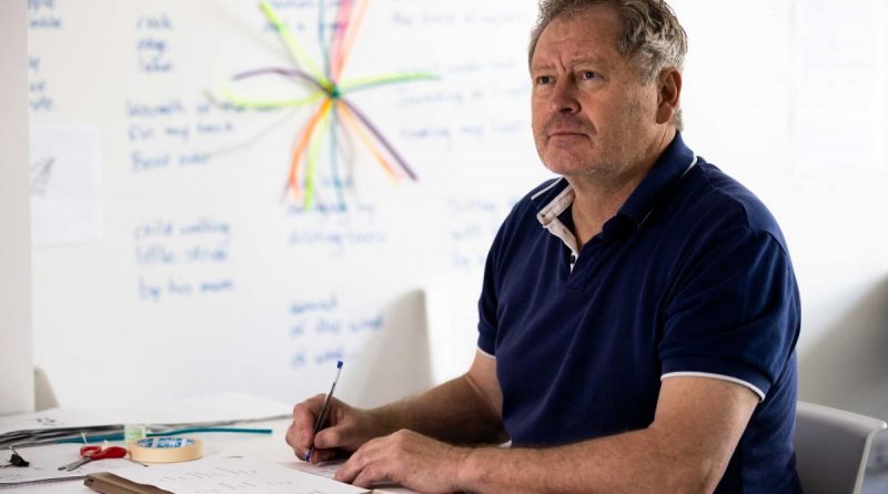 Squadron Leader David Wilkinson in front of his creative writing wall as part of the ARRTS 20.1 program. Photo by Corporal Robert Whitmore.