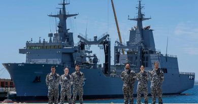 Marine technicians Able Seamen Greg Hallet, left, Cassandra Bullock, Mason Turner, Cody Martin, Yassi Coban and Leading Seaman Morse Stanton in front of NUSHIP Supply at Fleet Base West, Western Australia. Photo by Leading Seaman Ronnie Baltoft.