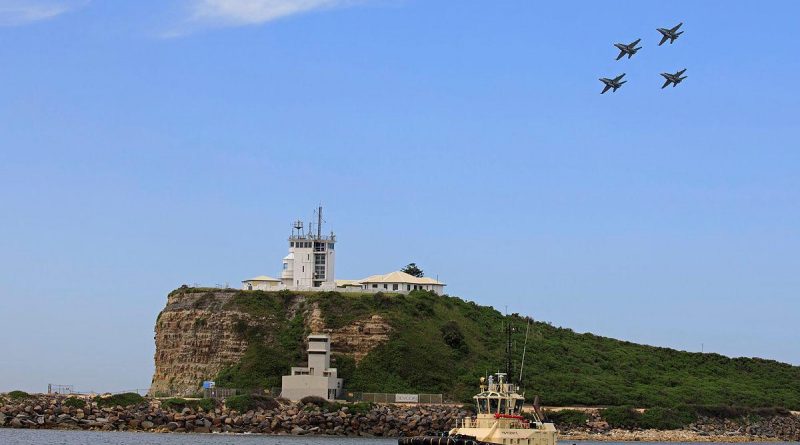 A formation of four F/A-18A/B Hornets over the lighthouse at Nobbys Beach in Newcastle. Photo by Corporal Brett Sherriff.