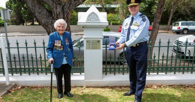 Senior Australian Defence Force Officer - Edinburgh Defence precinct Air Commodore Brendan Rogers presents a US Army Small Ships Section medallion to World War II veteran Thelma Zimmerman. Photo by Leading Aircraftwoman Jacqueline Forrester.