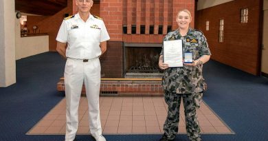 Captain Doug Theobald presents a Fleet Commander silver commendation to Able Seaman Sarah McDonald at an awards ceremony held at HMAS Stirling in Western Australia. Photo by Petty Officer Yuri Ramsey.