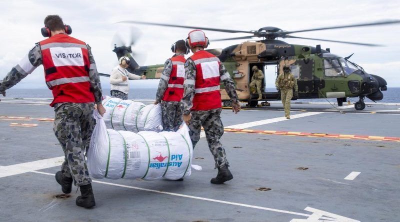 HMAS Adelaide sailors load disaster-relief supplies onto a MRH-90 Taipan bound for Nabouwalu on the island of Vanua Levu, Fiji, during Operation Fiji Assist 20-21. Photo by Corporal Dustin Anderson.