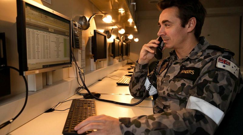 Leading Seaman Christopher Sanders answers a call on board HMAS Adelaide during Operation Fiji Assist. Photo by Corporal Dustin Anderson.