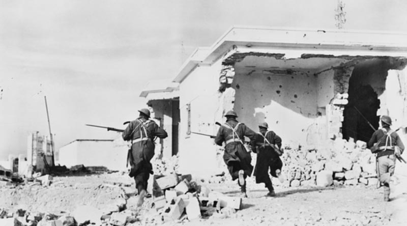 Australian soldiers enter the town of Bardia, Libia, on the second day of the Battle of Bardia. AWM006083 by unknown British official photographer.