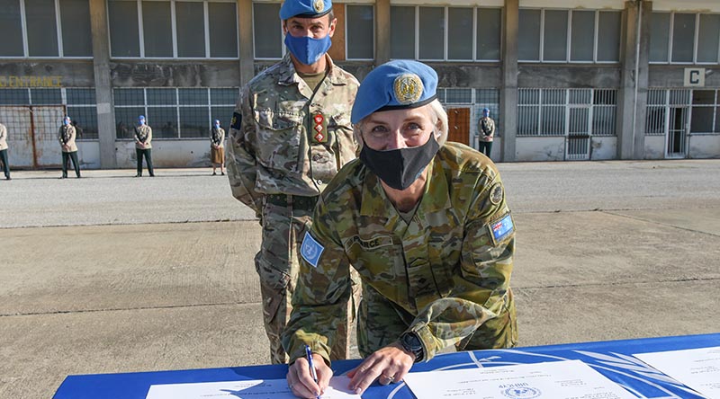 Major General Cheryl Pearce signs a Transfer of Authority certificate appointing Colonel Neil Wright as acting Officer in Charge of the military components in Cyprus until the new force commander arrives. Photographer unknown.