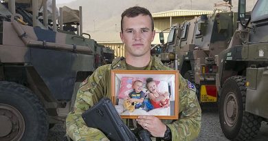 Private Kieren Morrissey, from Dubbo, deployed with Force Protection Element 10 on Operation Highroad in Kabul, Afghanistan, holds a photo of his children Aria and Sloane, on Father's Day 2018. Photo by Petty Officer Andrew Daken.