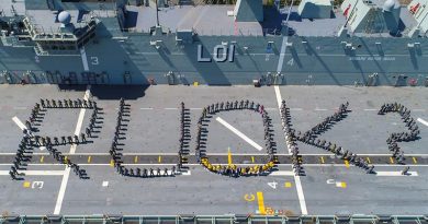 Officers and sailors on HMAS Adelaide's flight deck during a mental-health awareness event at Garden Island. Photo by Petty Officer Justin Brown.