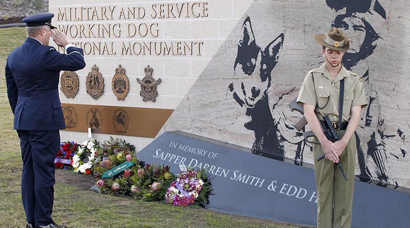 Commander Combat Support Group, Air Commodore Tim Innes, representing the Chief of Air Force, salutes the fallen after laying a wreath at the Military and Service Working Dog National Memorial. Photo by Corporal Peter Borys.