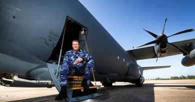 Specialist Reserve Public Affairs Officer Wing Commander Peter Overton on the steps of a No. 37 Squadron C-130J Hercules. Photo by Corporal David Said.