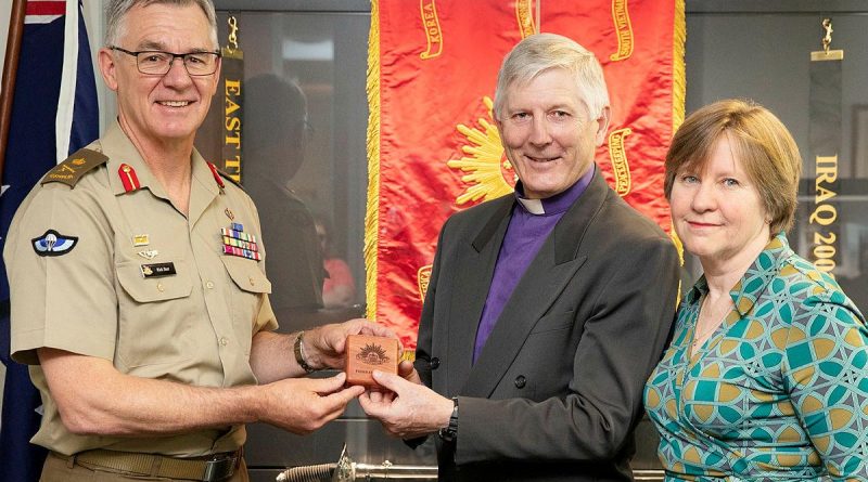 Chief of Army Lieutenant General Rick Burr presents a Federation Star to Bishop Grant Dibden alongside his wife Janet at Russell Offices, Canberra. Photo by Petty Officer Lee-Anne Cooper.