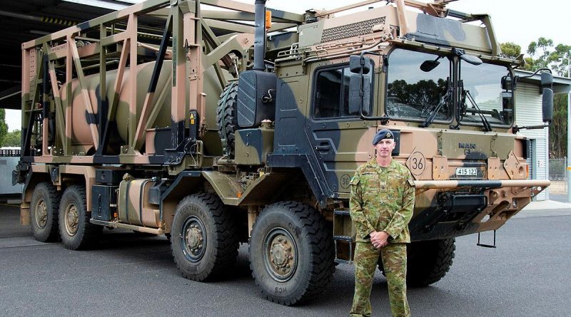 Warrant Officer Class 2 Lance Keighran in front of a MAN HX77 truck at the Army School of Transport in Puckapunyal, Victoria. Photo by Corporal William Spence.