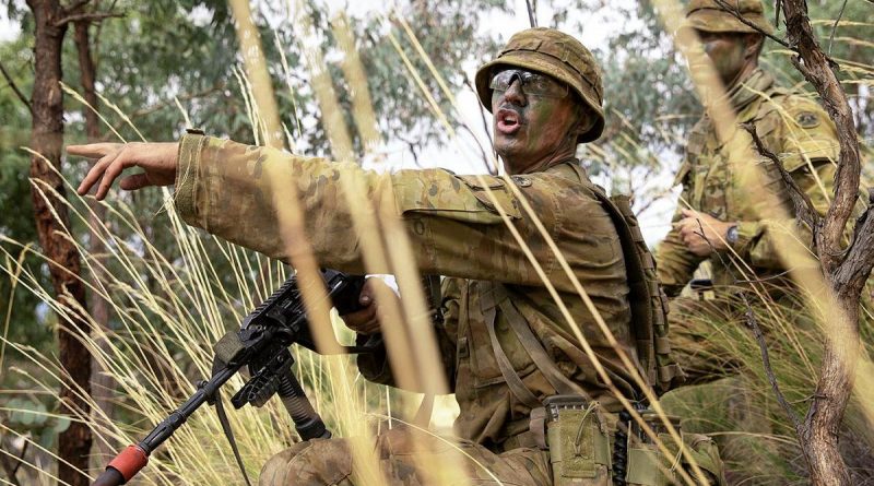 Army Officer Cadet Lachlan Goodall gives orders during a section attack at the Majura Training Area. Photo by Corporal Robert Whitmore.