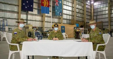 Major Justin Tomlinson, left, signs over authority to Major Simon Watch, right, with Commander JTF633 Rear Admiral Michael Rothwell. Photo by Sergeant Ben Dempster.