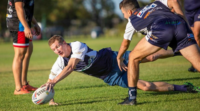 Petty Officer Stephen Swanson participates in a training session with the Navy Tridents rugby league team at the Lark Hill Sporting Complex in Port Kennedy, WA. Photo by Leading Seaman Ernesto Sanchez.