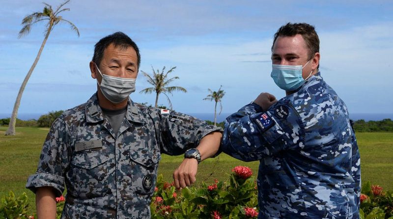 Chaplain Stuart Asquith shares a COVID-safe elbow tap with Warrant Officer Yoshiaki Tanide, of the Japan Air Self-Defense Force at Andersen Air Force Base in Guam. Photo by Technical Sergeant Jerilyn Quintanilla.