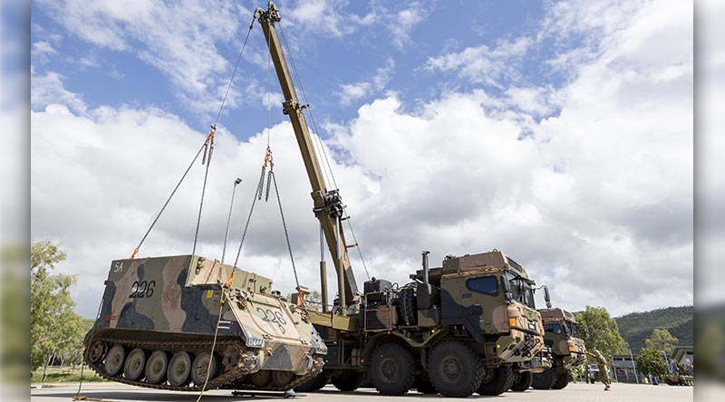 An Australian Army 45M heavy recovery vehicle from the 3rd Combat Service Support Battalion lifts an armoured personnel carrier during the 3rd Brigade combined-arms display at Lavarack Barracks, Townsville. Photo by Corporal Brodie Cross.