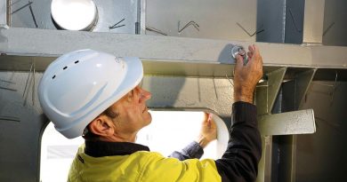 Luerssen Australia shipbuilder Malte Hoffman secures a coin inside the mast of the offshore patrol vessel Arafura in a mast-stepping ceremony held at Osborne Shipyard in South Australia.