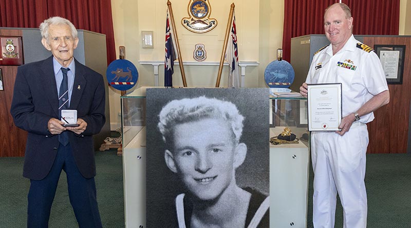 Former Able Seaman Ronald Bergman, 94, (and inset) is presented a World War II 75th anniversary commemorative medallion by the Executive Officer HMAS Cerberus Commander Martin Holzberger during Mr Bergman’s visit to the base. Photo by Leading Seaman James McDougall.