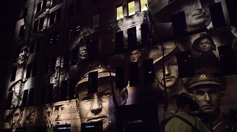 Faces of Australian war veterans projected on a facade in Martin Place, Sydney, during an Anzac Day dawn service. Photo by Able Seaman Bonnie Gassner.