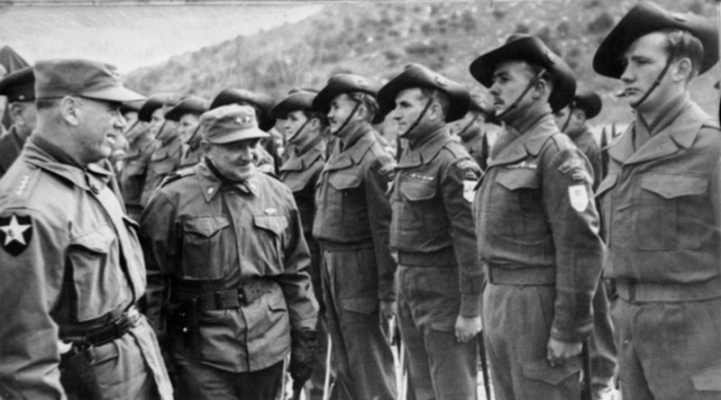 General J. van Fleet, General Officer, 8th US Army inspects members of the 3rd Battalion, Royal Australian Regiment (3RAR), while bestowing the presidential citation in recognition of the unit's action at Kapyong, Korea. AWM 083857