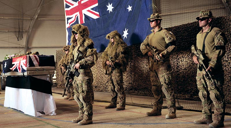 Snipers from Mentoring Task Force - Three form a guard around their recently fallen comrade, Private Matthew Lambert, at Tarin Kot, Afghanistan. Photo by Able Seaman Jo Dilorenzo.