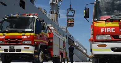 A Queensland Fire and Emergency Service fire truck is loaded onto HMAS Choules in Brisbane, while another two await loading, ahead of their transportation to Papua New Guinea. Photo by Major Anna-Lise Brink.